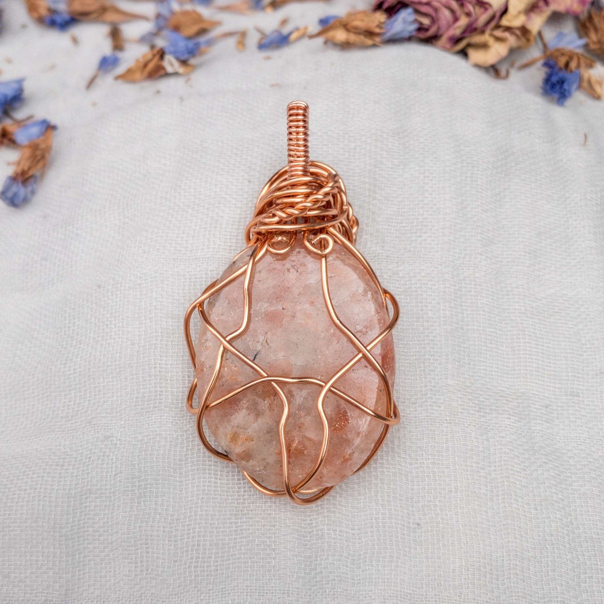 back of large sunstone wire wrapped in copper wire with rose wrap decal